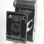 Black folding bellows camera.AGFA 127. Folds back into a narrow case with handle. Instruction book included.