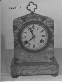 Physical description  Mantel clock in ash veneer on a spruce case