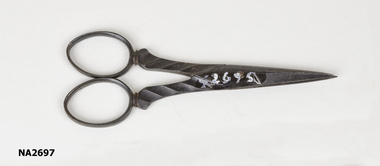 Small brown embroidery scissors.