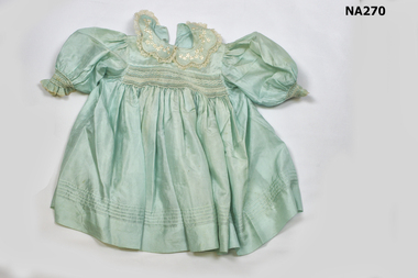 Child's silk aqua dress with smocking on bodice and sleeves. 