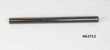 ound black ruler with imprint of rings on end