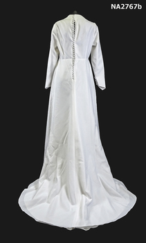 1978 White wedding dress in a fiber material with all over pattern embossed full length with train (back)