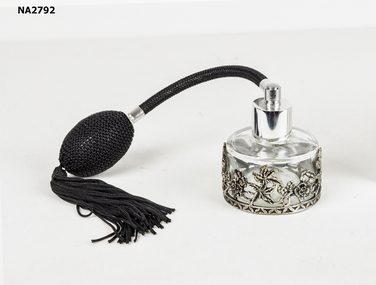Glass bottle with black pump and tassel. 