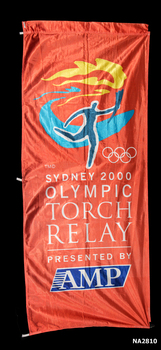Orange banner. Marathon Runner in blue over the five Olympic Rings.
