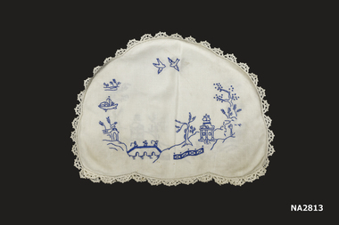 Hand embroiderer ed tea-cosy cover - white linen with fully crocheted scalloped lace edging and a mid blue embroidered design based on the Willow Pattern story.