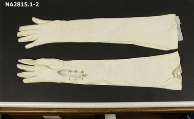 Full length white kid or doeskin leather evening gloves. 