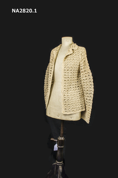 Knitted and crochet three piece costume of a jumper, jacket and skirt. Colour Old Gold.
