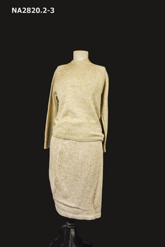 Knitted and crochet three piece costume of a jumper, jacket and skirt. Colour Old Gold.