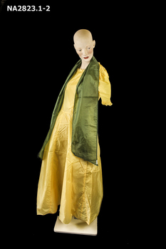  Long frock with short (cap) sleeves and a green sash.