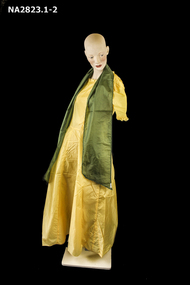  Long frock with short (cap) sleeves and a green sash.