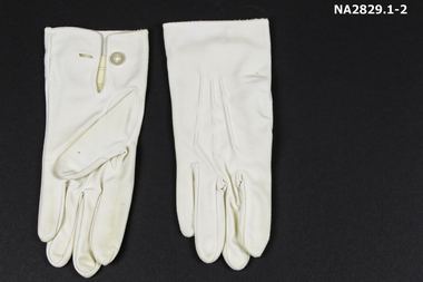 White nylon gloves with button at wrist.