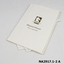 White cotton handkerchief with gold inscription folded into a white inscribed card.