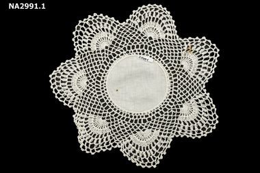 Crotched mat of six medallions linked around a centre circle.
