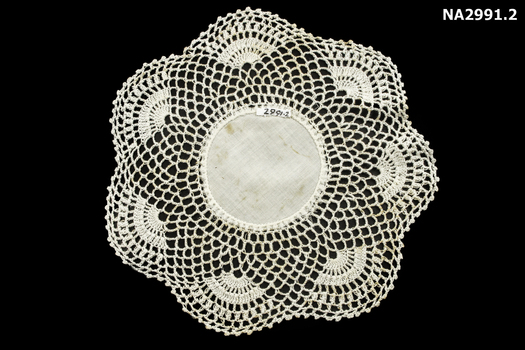Crotched mat of six medallions linked around a centre circle.