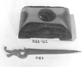 Oblong block of Mulga Wood with circular hole in middle to contain a black plastic inkwell.