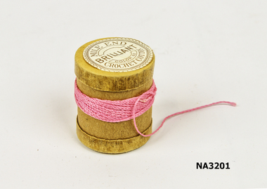A cotton reel made of cardboard comprising a cylinder with cap at each end.