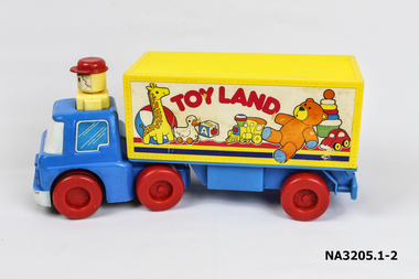A blue truck with a yellow man with red hat on the top.