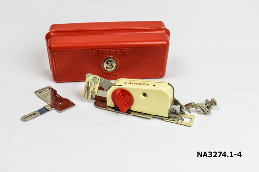 Sewing machine attachments in red plastic box.