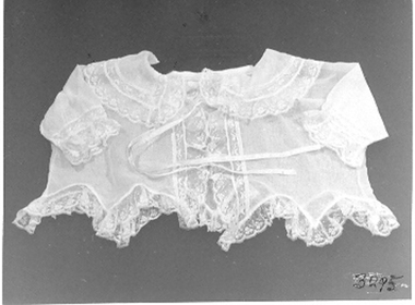 Creamy-white, fine voile baby's dress.