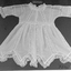 Creamy-white, fine voile baby's dress.