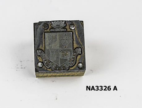 Small wooden block with metal Coat of Arms nailed to top