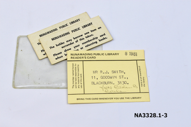 Yellow cardboard library card and two cardboard tokens 