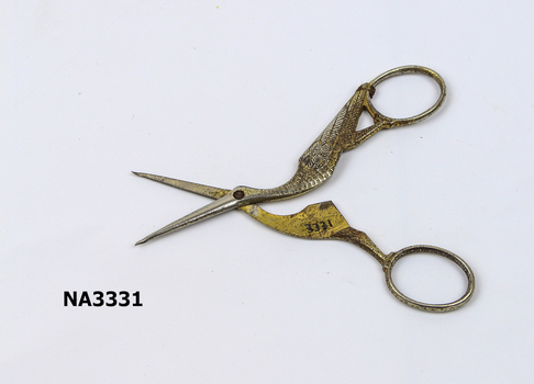 A pair of embroidery scissors in the shape of a stork; 