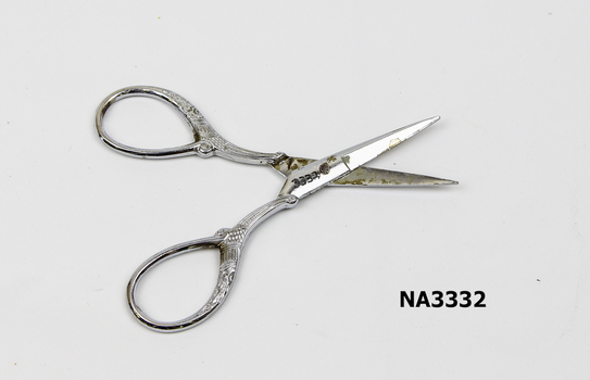 A pair of scissors for embroidery in silver coloured metal.