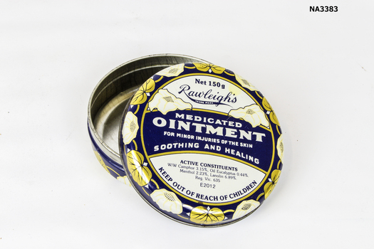 Round tin. Navy blue background with gold and white flower pattern around rims of both cover and base