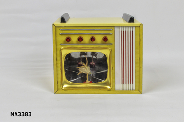 Toy television set. Case gold coloured tin with four red knobs on lower right hand side. 