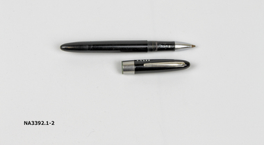 A black biro with lid. Silver pocket clip and silver band on lid.