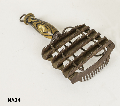 Curry comb made of mild steel and wood.  