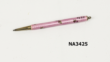 A pink plastic and metal dance card pencil, 