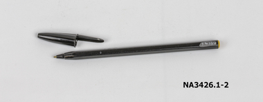 A black plastic biro and cap