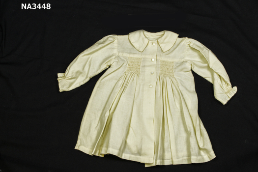 Cream viyella smocked baby's coat. 