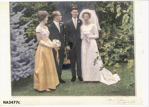 1963 Wedding dress of cream satin; floor length, short sleeves, round neckline, fitted at waist.