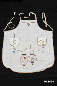 White cotton hand embroidered designs and two pockets.