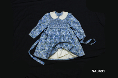 Blue floral childrens dress, smocked to the waist. 