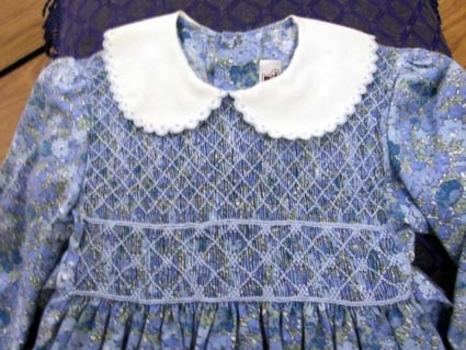 Blue floral childrens dress, smocked to the waist. 