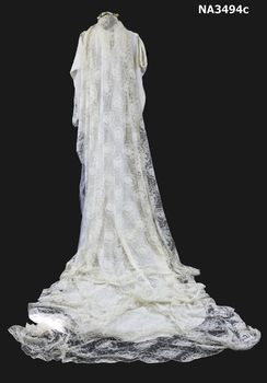 Cream damask 1938 satin dress. Long sleeves, cross over neckline to a diamond front panel. 