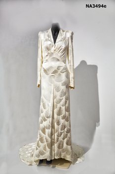 Cream damask 1938 satin dress. Long sleeves, cross over neckline to a diamond front panel. 