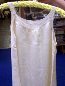 Cream sleeveless nightdress with round neckline. 