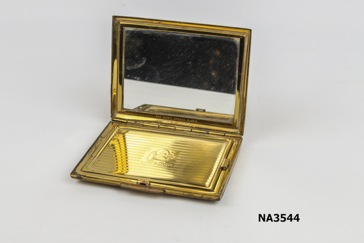 Oblong gilt case with pink enamel on lid.