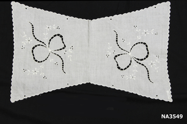 White linen butterfly shaped cloth, folded to form tea cosy cover.