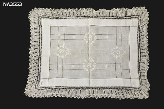 Ivory rectangular tray cloth with a knitted lace edge.