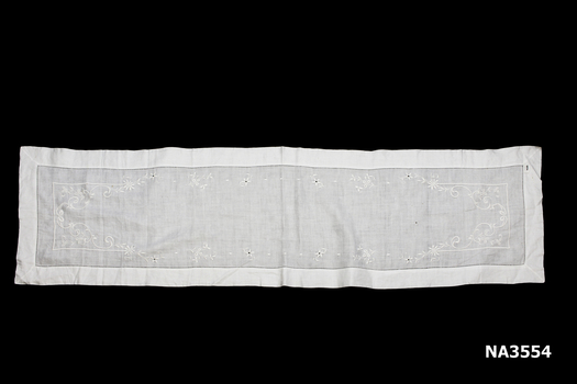 Fine white linen table runner with drawn threadwork hem and whitework embroidery of flowers, leaves and ribbon