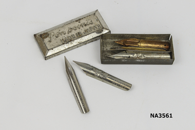 Small metal box containing 8 nibs