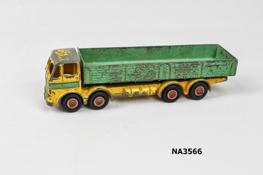Yellow and green painted truck with eight rubber tyred wheels