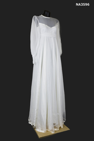 White chiffon 1978 round neck line dress with high waist, long sleeves; with cuff and six covered buttons.