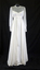 White chiffon 1978 round neck line dress with high waist, long sleeves; with cuff and six covered buttons.(front)
